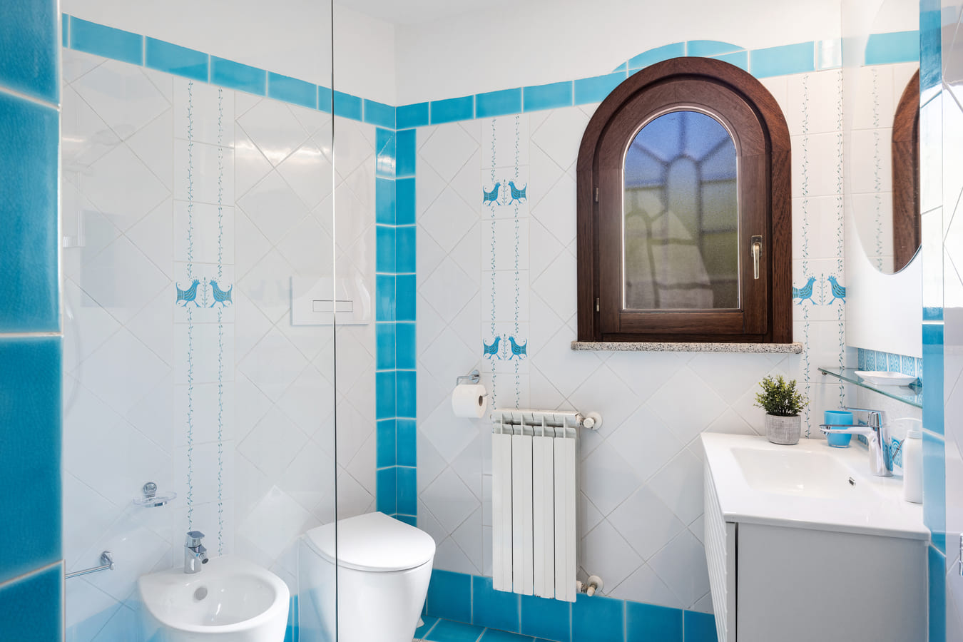 Bathroom with blue tiles and window