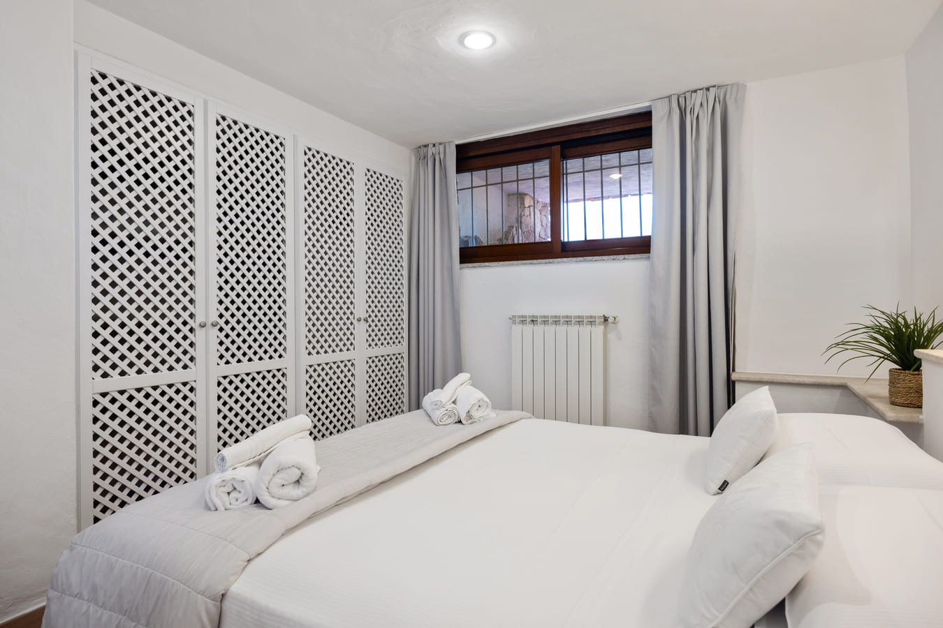 Double bedroom with white wardrobe and window