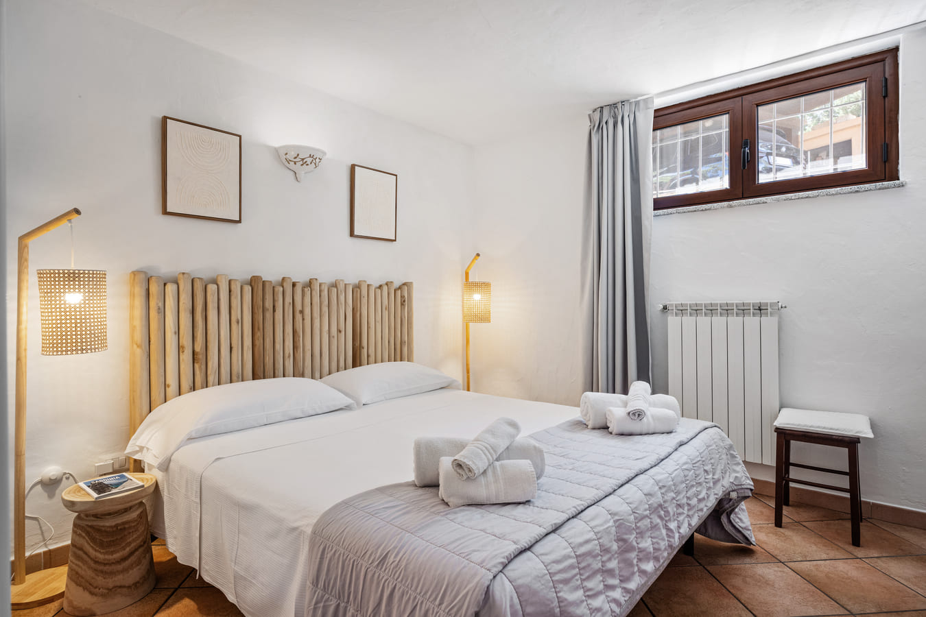 Double bedroom with wooden headboard and side lighting
